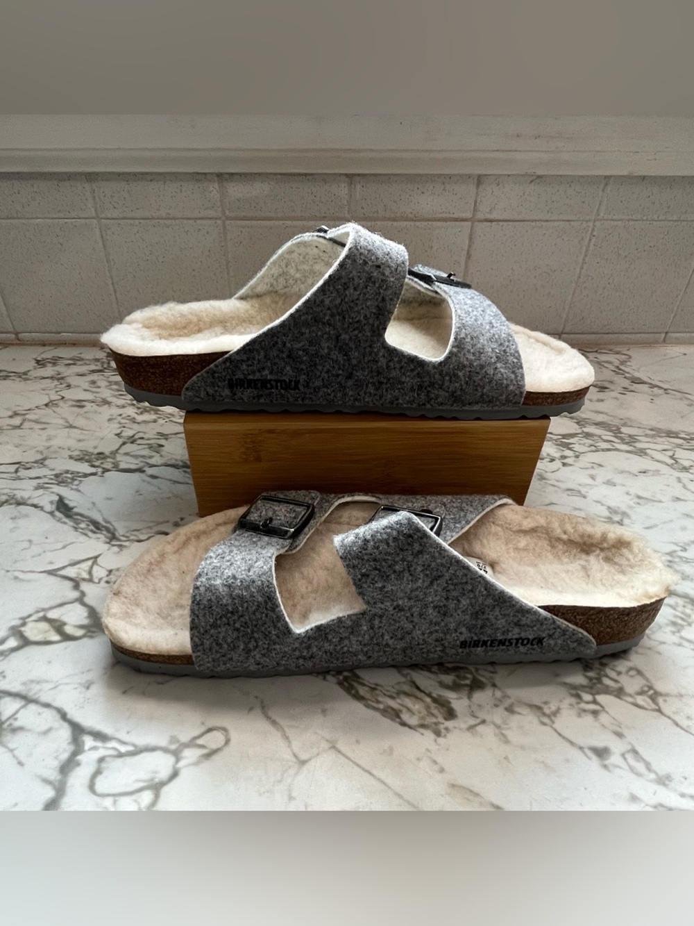 Birkenstock Arizona Happy Lamb / Rivet Sandals in a light gray colorway.